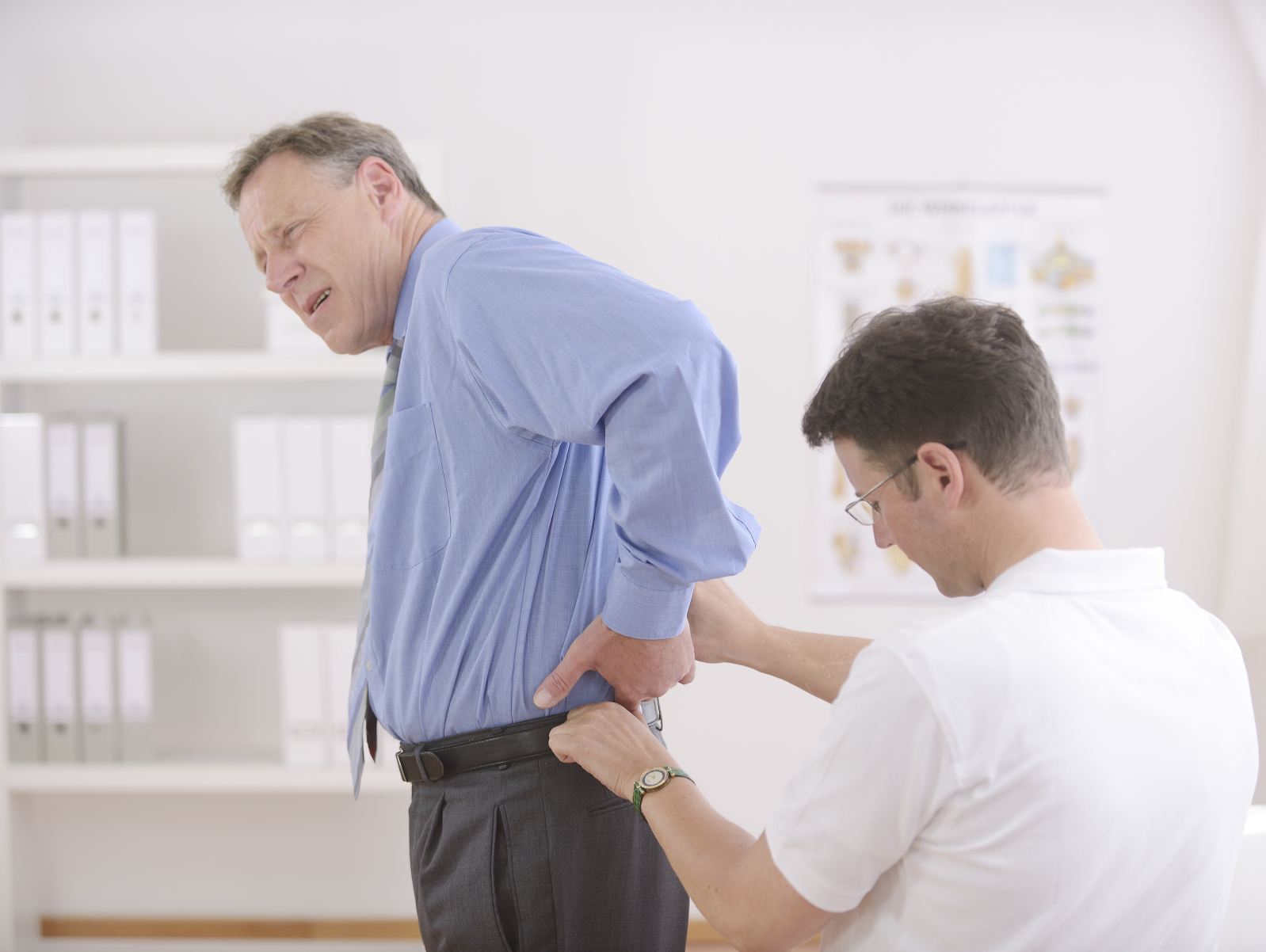 Chiropractor diagnosing patients back injury after car accident